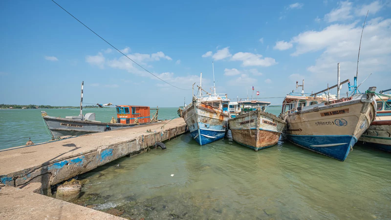 Traditional fishing boats and endless ocean horizons at Battalangunduwa sandspit island off Kalpitiya Sri Lanka
