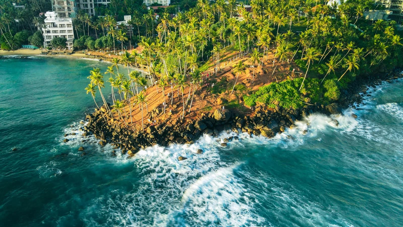 Expansive panoramic view of an idyllic secluded beach cove with pristine sands.
