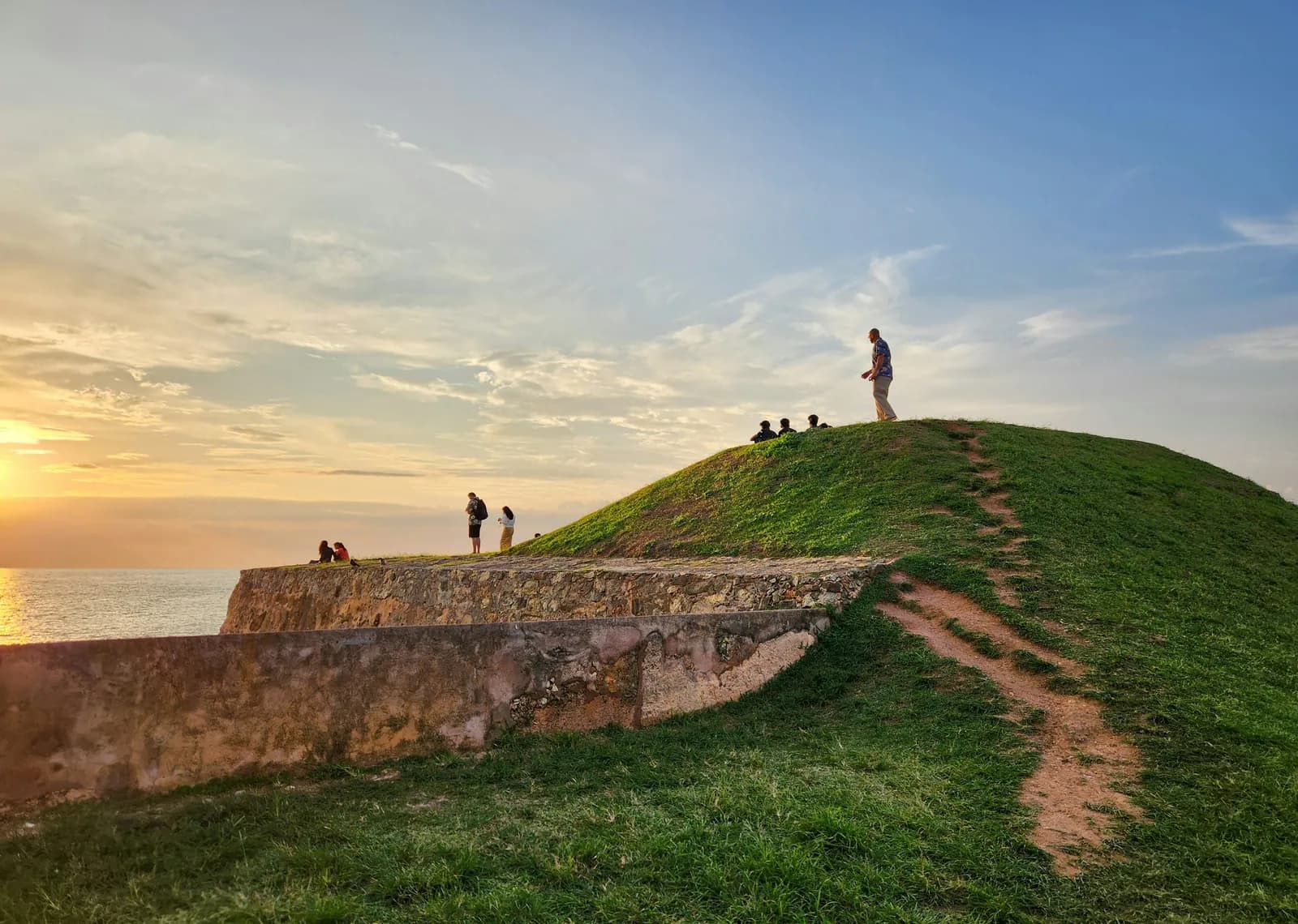 Historic Dutch ramparts and lighthouse of Galle Fort during a golden sunset, reflecting Sri Lanka's shared Dutch VOC heritage.