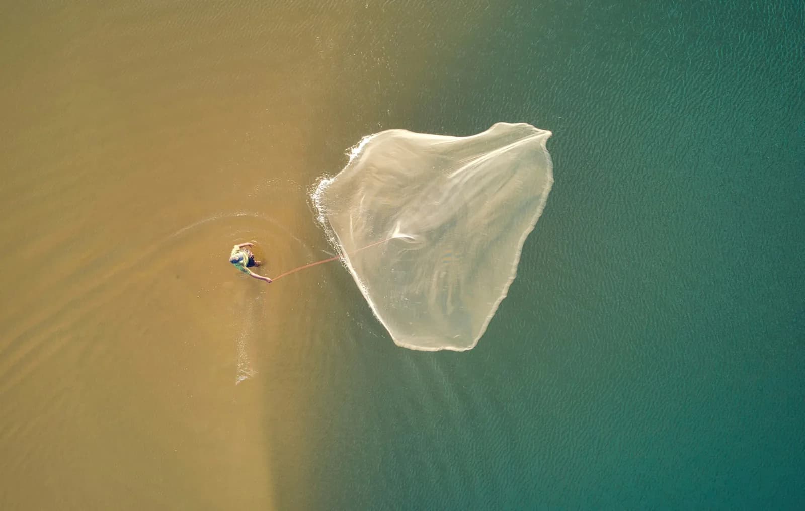 Local fishermen tending their nets along the golden shoreline.